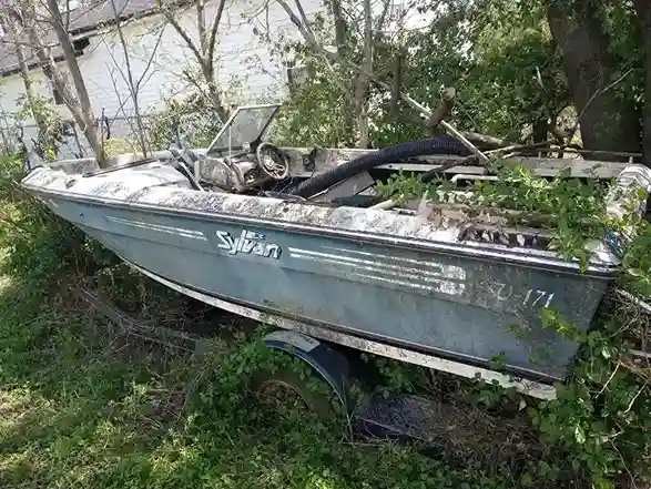 Abandoned boat in brush