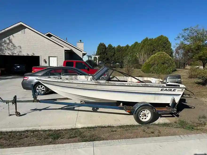 Boat on trailer in driveway