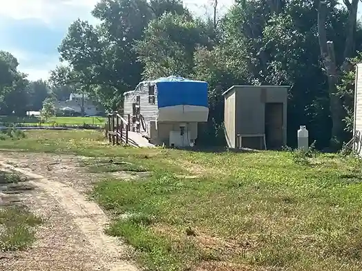 Camper parked by a shed