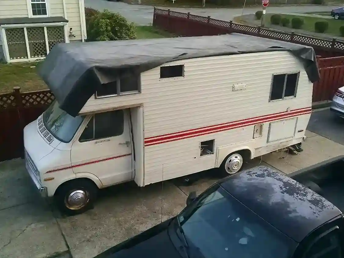 Old RV side view on a driveway