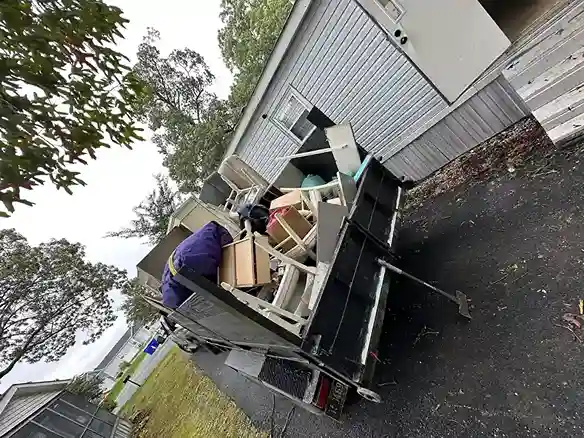 Red truck towing a debris trailer