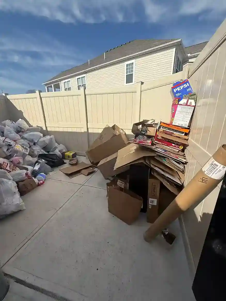 Trash bags stacked along a wall