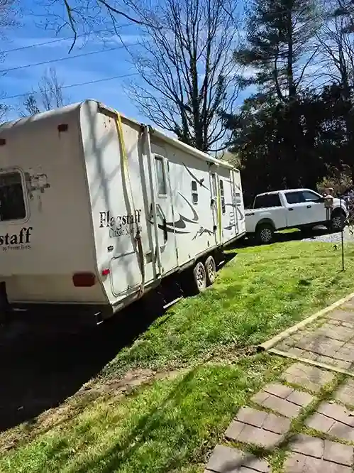 Travel trailer parked on a grassy lawn