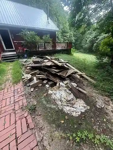 Yard debris pile by a house